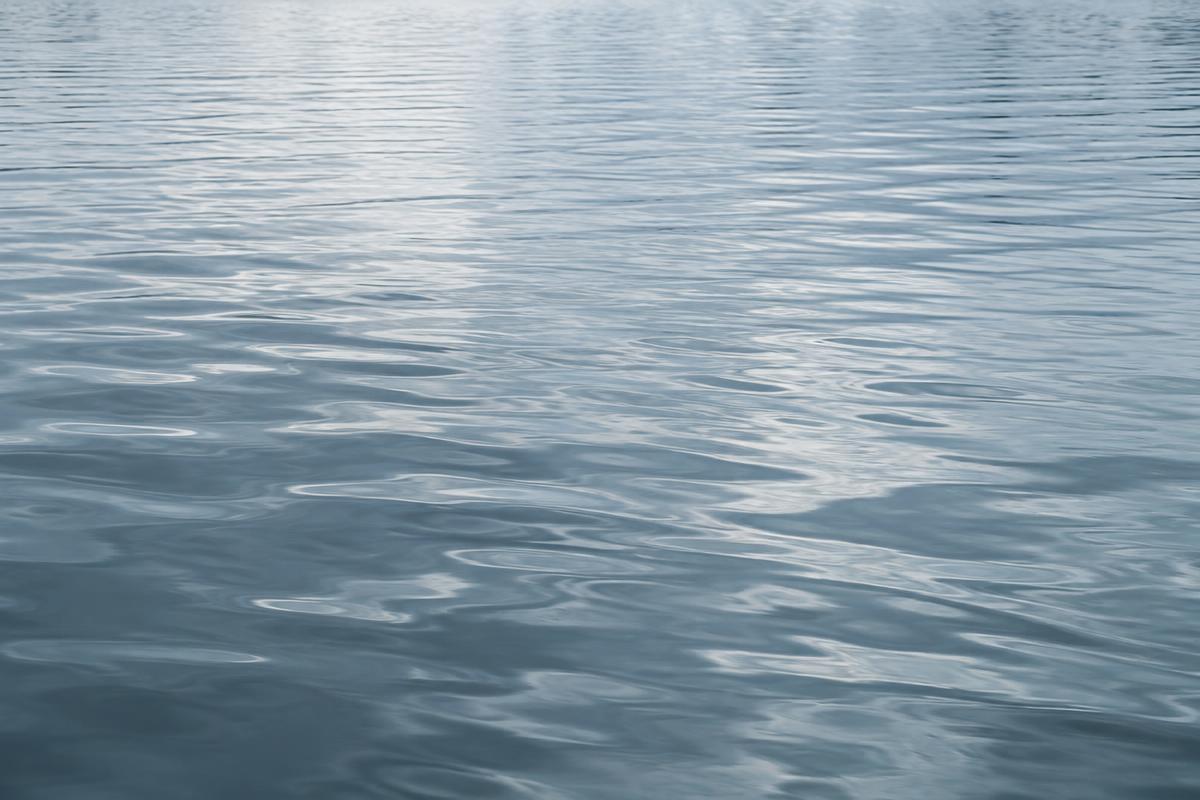Soft daylight on gentle blue-grey lake ripples