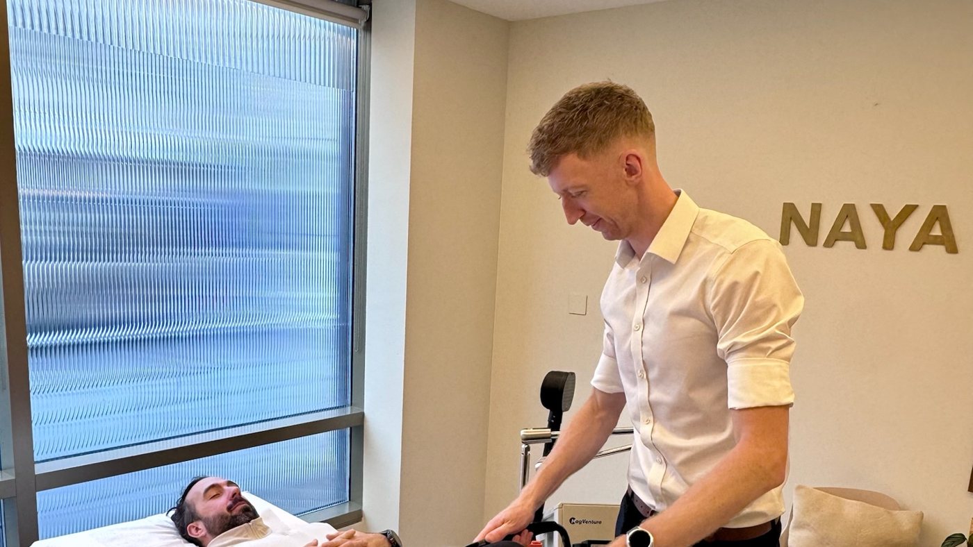 A Naya practitioner treating a patient lying on the treatment bed at the Marylebone clinic