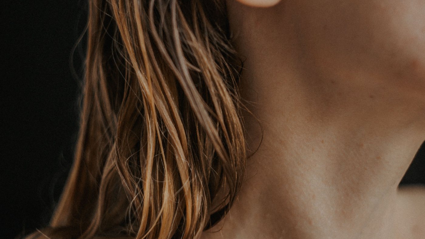 Close-up of the back of a woman’s neck and shoulder